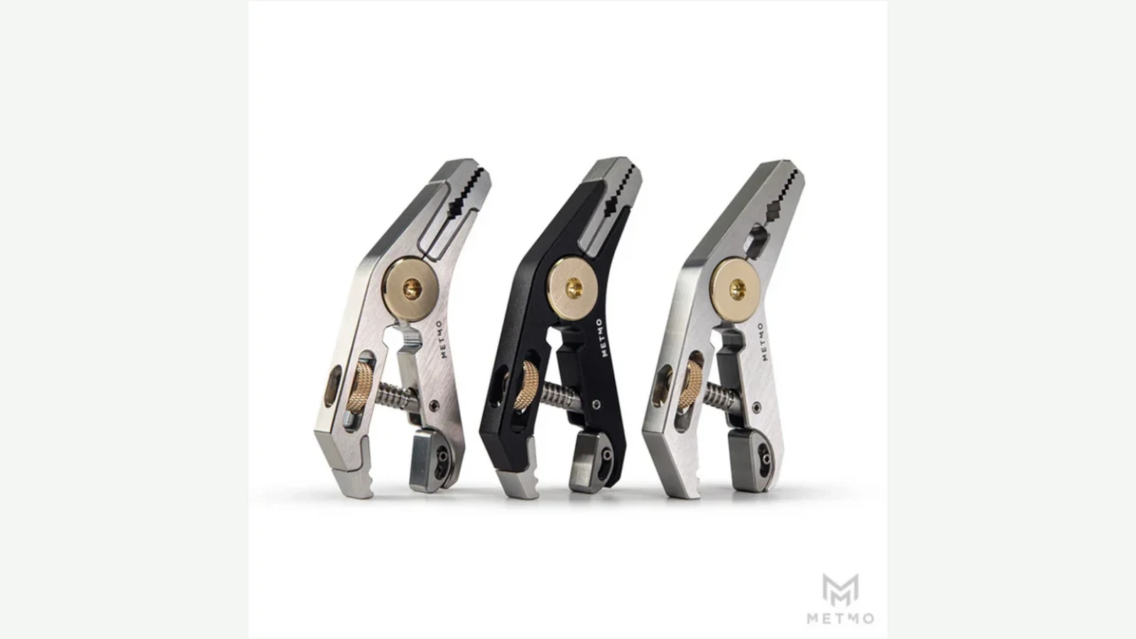 Three MetMo Pocket Grip tools in stainless, black aluminum and titanium finishes